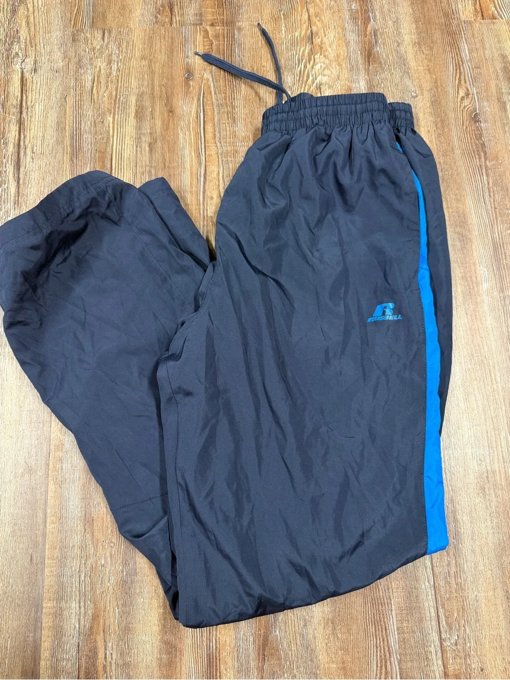 Vintage Russell Athletic navy blue track pants with blue side stripe, size M